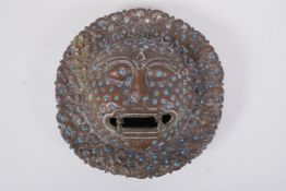 A Tibetan bronze temple lion mask, inset with turquoise stones, 22cm diameter