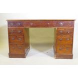 A Victorian mahogany nine drawer pedestal desk with gilt tooled leather inset top and ring pull