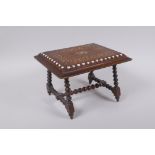 An antique mahogany stand in the form of a table, with sadeli inlaid decoration to top and turned