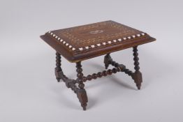 An antique mahogany stand in the form of a table, with sadeli inlaid decoration to top and turned