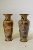 A pair of Royal Doulton leaf decorated vases, impressed mark to base, signed E.B., 40cm high
