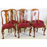 A set of six mahogany dining chairs with shaped backs and drop in seats