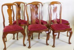 A set of six mahogany dining chairs with shaped backs and drop in seats