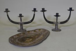 A pair of Malaysian horn two branch candlesticks with silver mounts, one sconce loose, and a white