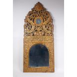 An Ottoman carved giltwood wall mirror with Islamic script and Hijri date decoration, 37 x 84cm