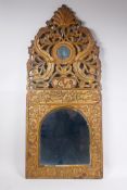 An Ottoman carved giltwood wall mirror with Islamic script and Hijri date decoration, 37 x 84cm