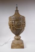 A composition wood effect table lamp in the form of a carved wood urn, 71cm high without shade