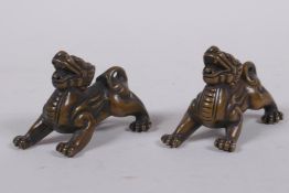 A pair of Chinese bronze kylin scroll weights, 5cm long