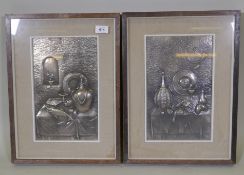 A pair of silver plated repousse plaques decorated with still life scenes housed in picture box