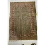 A fine woven green ground Turkish rug with an allover Bokharra style design, 130 x 182cm