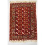 A Persian reg ground wool rug with geometric design, 108 x 148cm