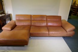 A Natuzzi leather corner sofa in two sections, with adjustable arms and backs, 316 x 160 x 90cm with