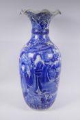 A Japanese Meiji period blue and white porcelain vase with a frilled rim, decorated with geisha