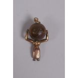 A 9ct gold touch wud charm in the form of a woman, reg.622322?, 2.5cm long