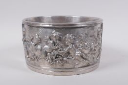 A silvered composition pot with raised putti decoration, 20cm diameter