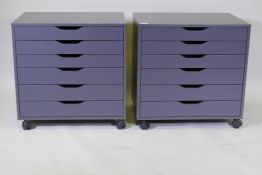 A pair of contemporary painted chests/filing cabinets with six graduated drawers, raised on castor