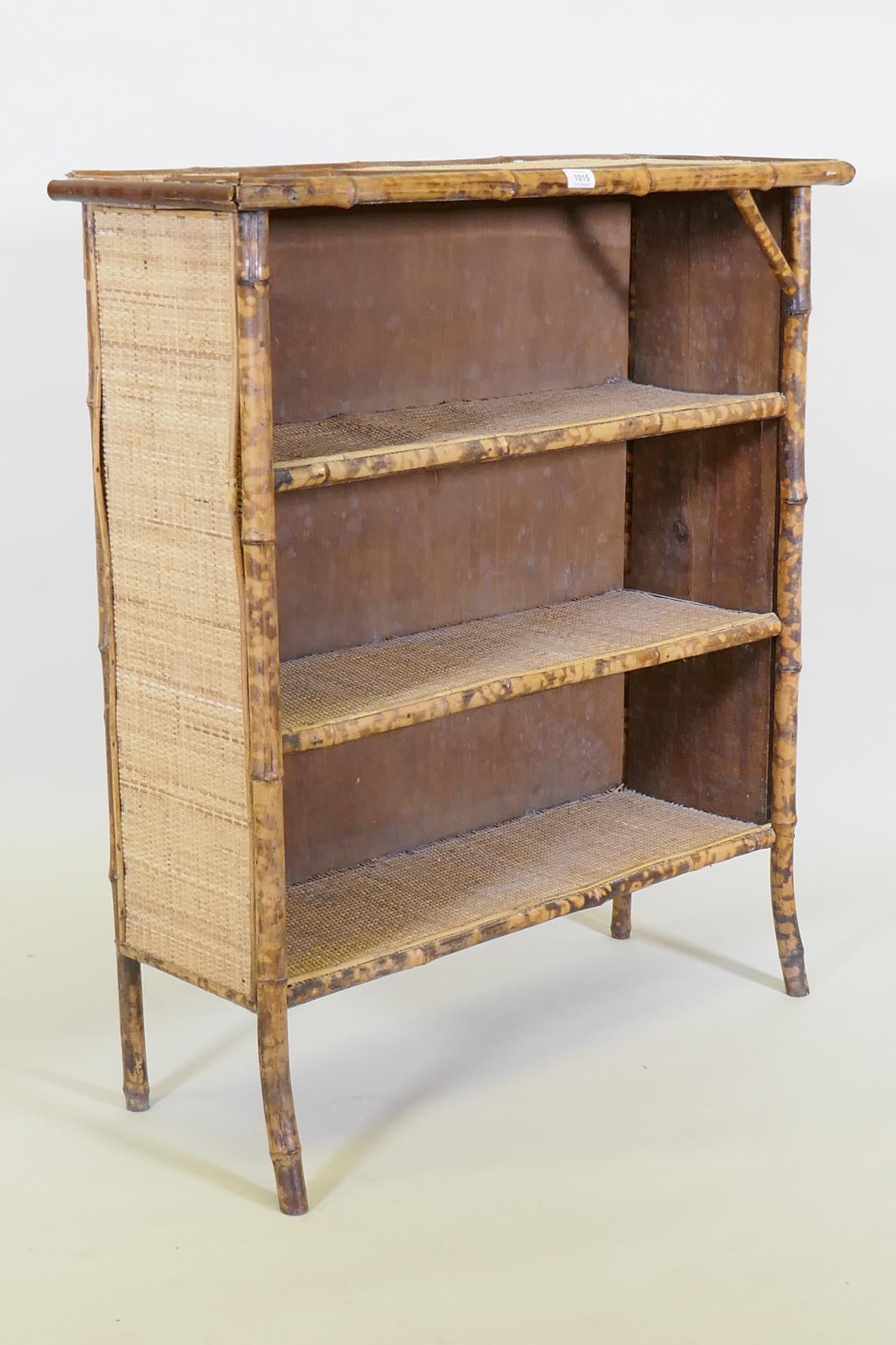 A bamboo and rattan three tier open bookcase, 88 x 32cm, 100cm high