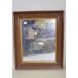 A C19th wall mirror with wood and composition frame, decorated with a frieze of acorns and leaf,