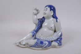 A Chinese blue and white porcelain reclining figure with a toad and coin, impressed seal mark to