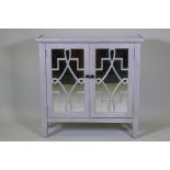 A contemporary silver leafed side cabinet with mirror glass top and cupboard doors, 82 x 30 x 82cm