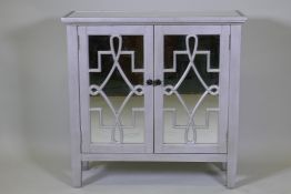 A contemporary silver leafed side cabinet with mirror glass top and cupboard doors, 82 x 30 x 82cm