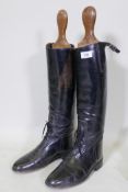 A pair of vintage leather riding boots with wood trees, boot sole 30cm long