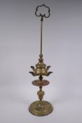 An antique brass four spout whale oil lamp, 65cm high