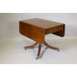 A George III mahogany pembroke table with single end drawer, raised on a turned column and splay