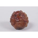 A Japanese carved hardwood netsuke with dragon decoration, signed, 4cm diameter