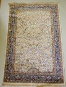 An ivory ground Kashmir full pile rug with tree of life design with blue borders, 158 x 234cm