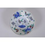 A Doucai porcelain rice bowl with chicken decoration to the interior and incised bird and berry
