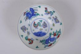 A Doucai porcelain rice bowl with chicken decoration to the interior and incised bird and berry