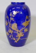 A Carltonware vase with gilt and enamel decoration on a blue glaze, 27cm high