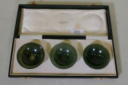A set of three spinach jade bowls in a presentation case inscribed H. Simmons, 60 & 61 Burlington