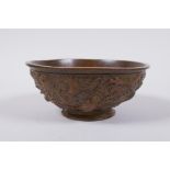 A Chinese bronze trinket bowl with raised dragon decoration, Qianlong 4 character mark to base, 11cm