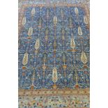 An Afghan hand woven and knotted Choeb Rang carpet, geometric designs in a muted palette on a blue