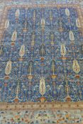 An Afghan hand woven and knotted Choeb Rang carpet, geometric designs in a muted palette on a blue