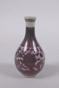 A Chinese Ming style miniature red and white porcelain bottle vase with scrolling lotus flower