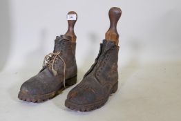 A pair of vintage climbing boots with steel studs and wood trees, one section lacking, 29cm long