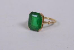 A French yellow metal ring, hallmarked 18ct, set with a green glass stone (chipped), 3.7g gross
