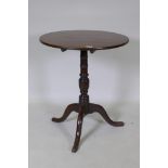 A Georgian tilt top oak table, raised on a canon barrel turned column with tripod supports, adapted,