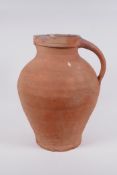 An antique terracotta jug, AF chips