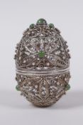 A Russian silver filigree egg with inset jade cabochons,maker's mark IVZ in cyrillic, 6.5cm high