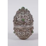 A Russian silver filigree egg with inset jade cabochons,maker's mark IVZ in cyrillic, 6.5cm high