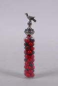 A Peruvian 950 silver topped vial with a bird knop the vial containing rosary peas (Abrus