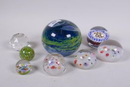 A large Mdina glass paperweight with swirled and bubbled decoration, 12cm diameter, two millefiore