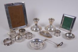 A quantity of assorted silver including photo frames, American dwarf candlesticks, napkin rings,