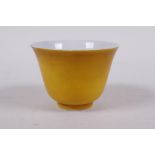 A yellow ground porcelain tea bowl, Chinese KangXi 6 character mark to base, 5cm high x 7cm diameter