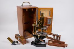 An antique German brass microscope by E. Leitz Wetzlar, No. 108525, with accessories in a fitted