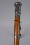 A Chinese silver topped cane with repousse decoration of a figure in a landscape, and a silver